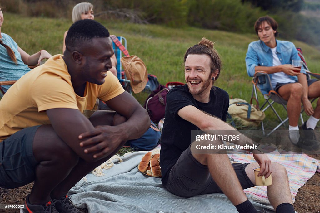 Friends laughing together on camping trip