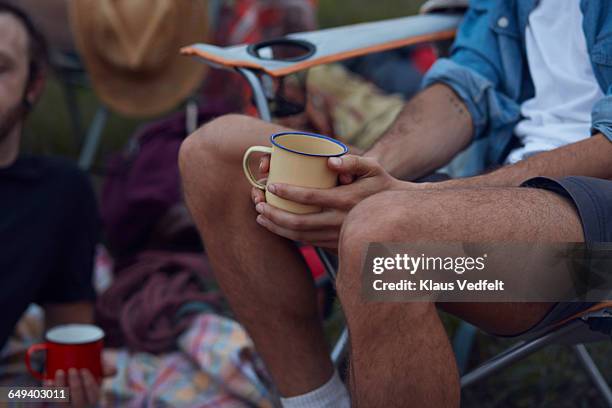 close-up of male hands holding tincup, at campsite - metallic shorts stock pictures, royalty-free photos & images