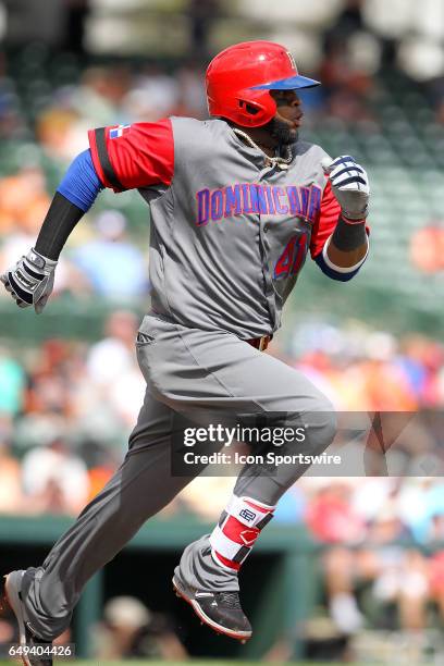 Carlos Santana of the Dominican Republic hustles down to first base during the spring training game between the WBC's Dominican Republic and the...