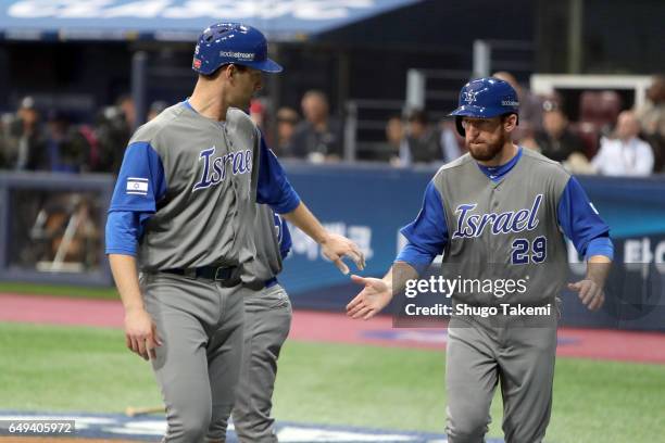 Nate Freiman and Ike Davia of Team Israel celebrate after they both scored a run in the seventh inning during Game 2 of Pool A against Team Chinese...