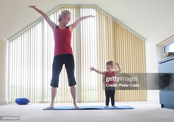 mother and toddler exercising together - tall blonde women stock pictures, royalty-free photos & images