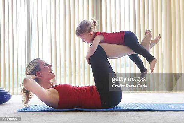 mother and toddler exercising - woman and toddler stock pictures, royalty-free photos & images