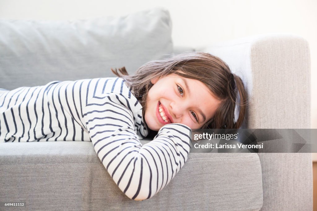 Portrait of a girl lying on sofa