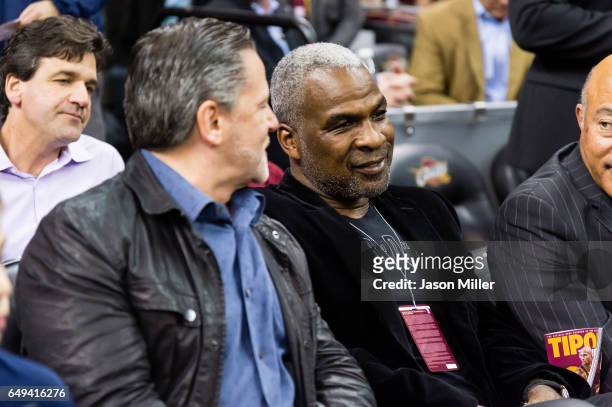 Cleveland Cavaliers owner Dan Gilbert sits next to former NBA player Charles Oakley prior to the game between the Cleveland Cavaliers and the New...