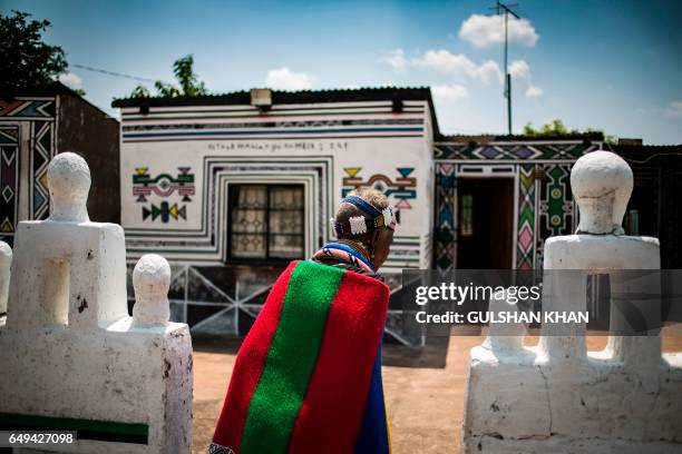 South African artist Esther Mahlangu walks through her home in Mabhoko Village, Siyabuswa, Mpumalanga on March 6, 2017. Mahlangu recently opened her...