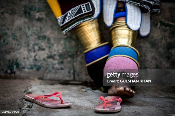 This photo taken on March 6, 2017 at the home of South African artist Esther Mahlangu in Mabhoko Village, Siyabuswa, Mpumalanga, shows the rings and...