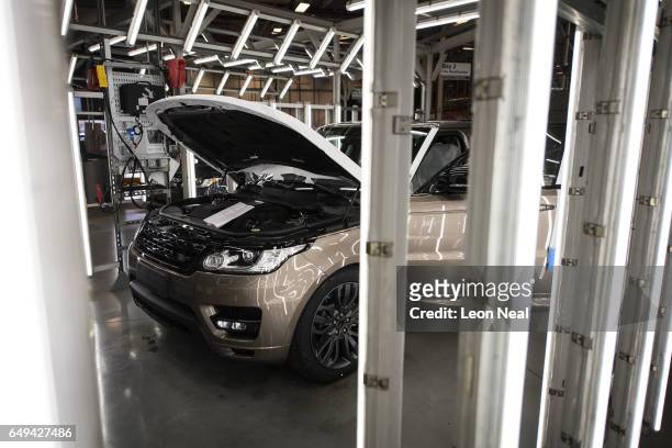 Cars are inspected at the final stage of production at the Jaguar Land Rover factory on March 1, 2017 in Solihull, England. The company has pledged...