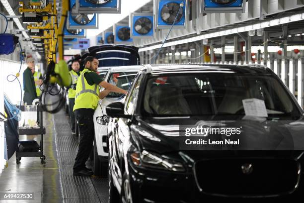 Vehicles are checked before moving to the next stage of production at the Jaguar Land Rover factory on March 1, 2017 in Solihull, England. The...