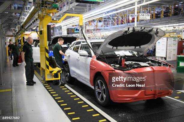 Doors are fitted and checked during production at the Jaguar Land Rover factory on March 1, 2017 in Solihull, England. The company has pledged it's...