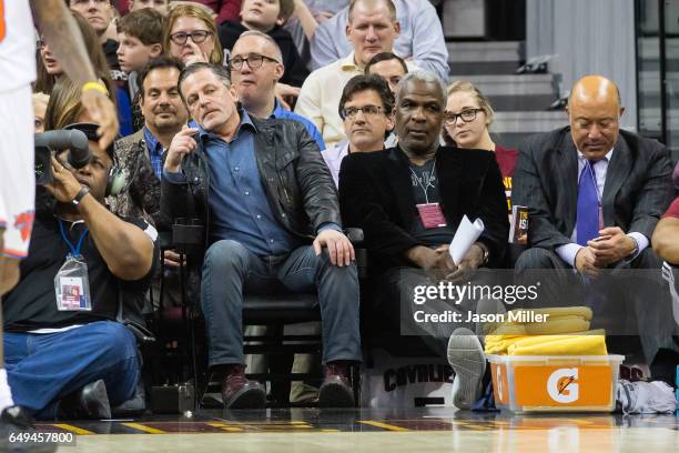 Cleveland Cavaliers owner Dan Gilbert sits next to former NBA player Charles Oakley during the game between the Cleveland Cavaliers and the New York...