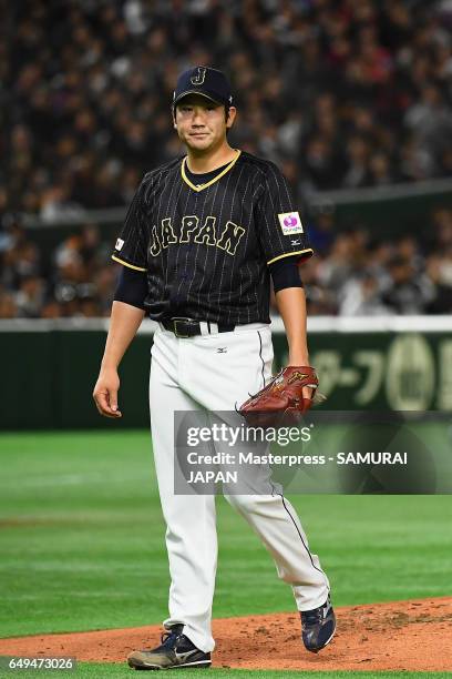 Starting Pitcher Tomoyuki Sugano of Japan shows dejection after allowing a solo homer to Catcher Allan de San Miguel of Australia in the bottom of...