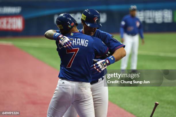 Outfielder Chih-Hao Chang of Chinese Taipei celebrates with his team mate Chih-Sheng Lin after hitting a two-run homer to make it 4-4 in the top of...