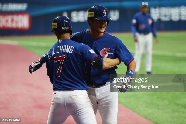 Outfielder Chih-Hao Chang of Chinese Taipei celebrates with his team mate Chih-Sheng Lin after hitting a two-run homer to make it 4-4 in the top of...