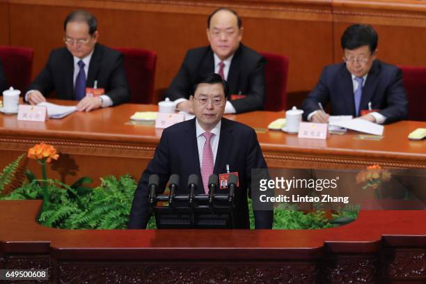 Chairman of the Standing Committee of the National People's Congress Zhang Dejiang delivers his work report during the 2nd plenary session of the...