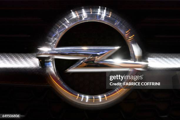 The logo of Opel is seen on a car at the carmaker stand during the second press day of the Geneva International Motor Show on March 8, 2017 in...