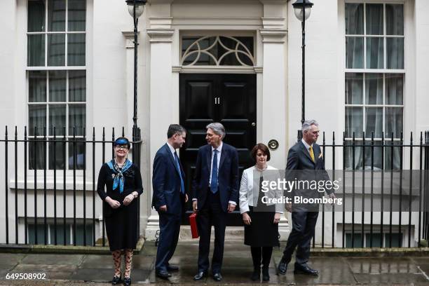 From left to right, Lucy Neville-Rolfe, commercial secretary to the U.K. Treasury, David Gauke, chief secretary to the U.K. Treasury, Philip Hammond,...