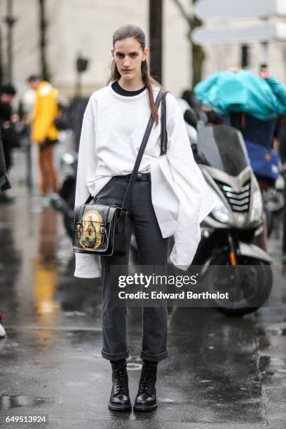 Model wears a white top, outside the Celine show, during Paris Fashion Week Womenswear Fall/Winter 2017/2018, on March 5, 2017 in Paris, France.