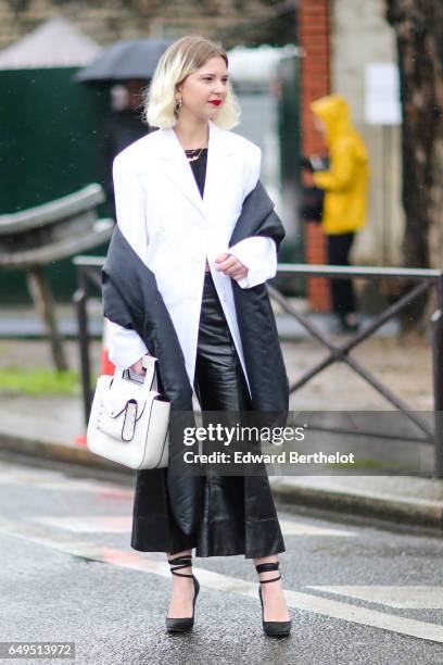 Guest wears a white suit jacket, and black pants, outside the Celine show, during Paris Fashion Week Womenswear Fall/Winter 2017/2018, on March 5,...