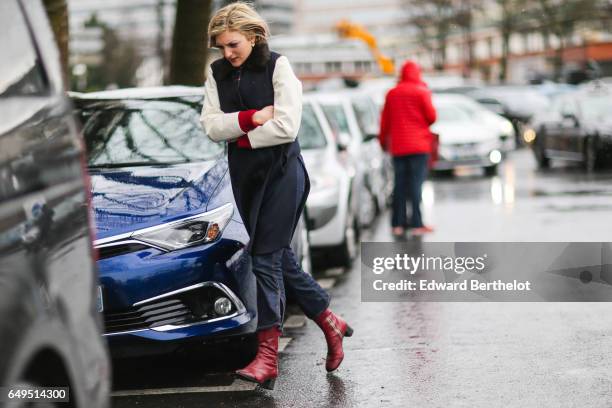 Guest wears red leather boots, outside the Celine show, during Paris Fashion Week Womenswear Fall/Winter 2017/2018, on March 5, 2017 in Paris, France.