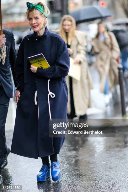 Guest wears a blue coat and blue shoes, outside the Celine show, during Paris Fashion Week Womenswear Fall/Winter 2017/2018, on March 5, 2017 in...