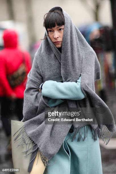 Guest wears a gray scarf and a blue coat, outside the Celine show, during Paris Fashion Week Womenswear Fall/Winter 2017/2018, on March 5, 2017 in...