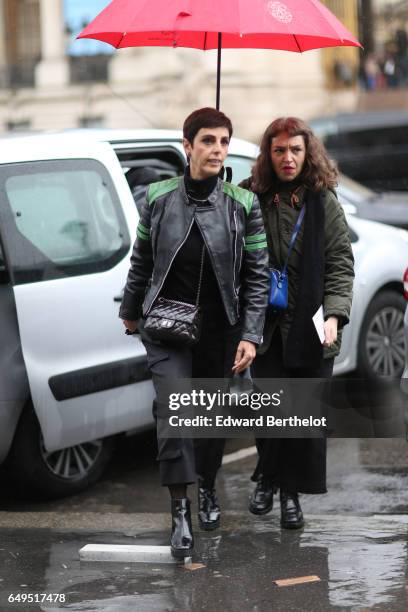 Guest wears a black leather jacket and a Chanel bag, outside the Elie Saab show, during Paris Fashion Week Womenswear Fall/Winter 2017/2018, on March...