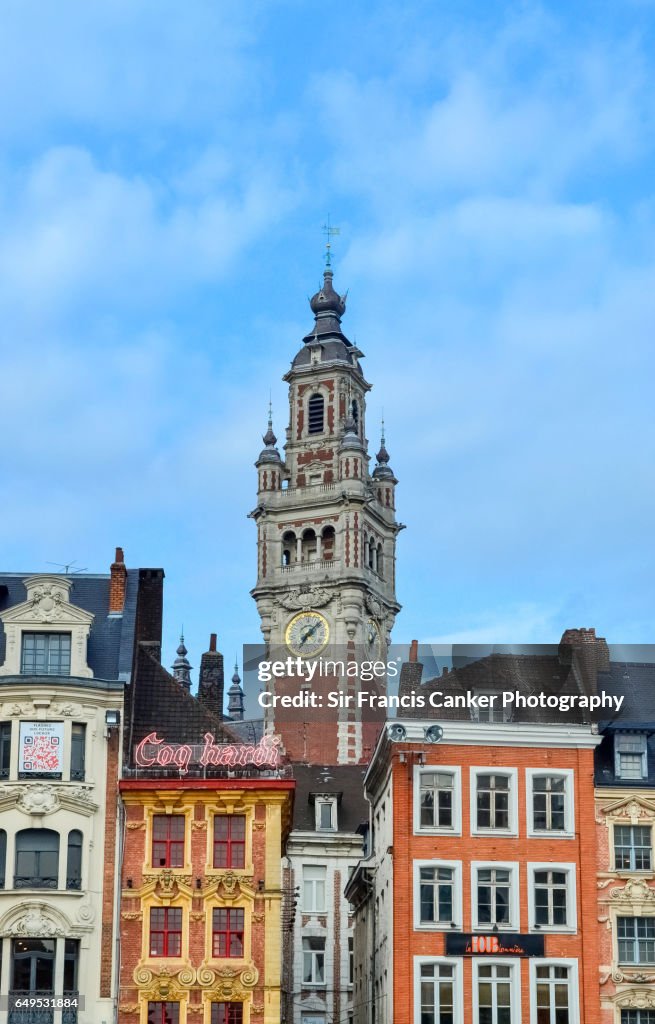 Lilly cityscape with Chamber of Commerce building belfry rising behind old colorful houses, France