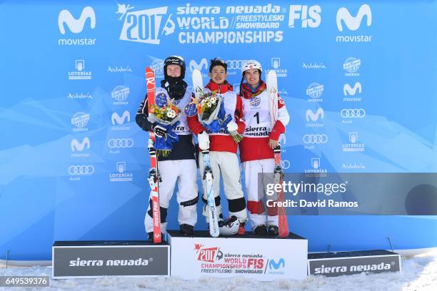 Sliver medalist Benjamin Cavet of France, gold medalist Ikuma Horishima of Japan and bronze medalist Mikael Kingsbury of Canada pose during the...