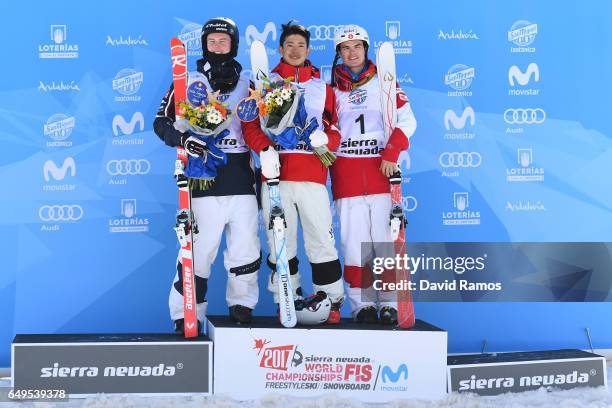 Sliver medalist Benjamin Cavet of France, gold medalist Ikuma Horishima of Japan and bronze medalist Mikael Kingsbury of Canada pose during the...