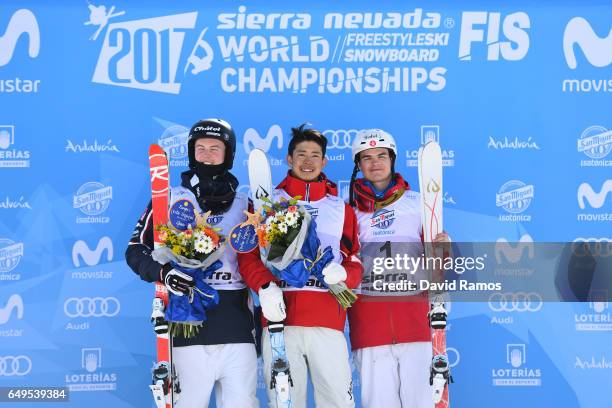 Sliver medalist Benjamin Cavet of France, gold medalist Ikuma Horishima of Japan and bronze medalist Mikael Kingsbury of Canada pose during the...