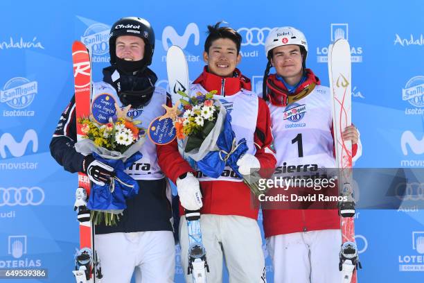 Sliver medalist Benjamin Cavet of France, gold medalist Ikuma Horishima of Japan and bronze medalist Mikael Kingsbury of Canada pose during the...