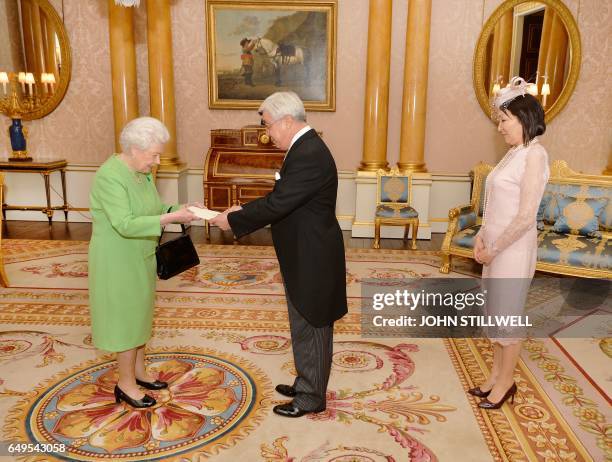 Britain's Queen Elizabeth II greets Erlan Idrissov, Kazakhstan's Ambassador to the United Kingdom, and his wife Mrs Idrissova, during a private...