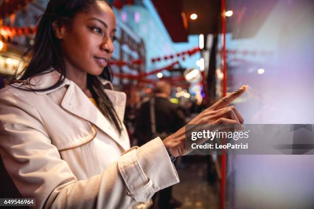 woman placing an order using a touch screen - billboards 2017 stock pictures, royalty-free photos & images