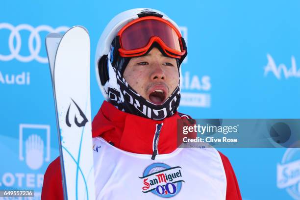 Gold medalist Ikuma Horishima of Japan poses during the flower ceremony for the Men's Moguls on day one of the FIS Freestyle Ski & Snowboard World...