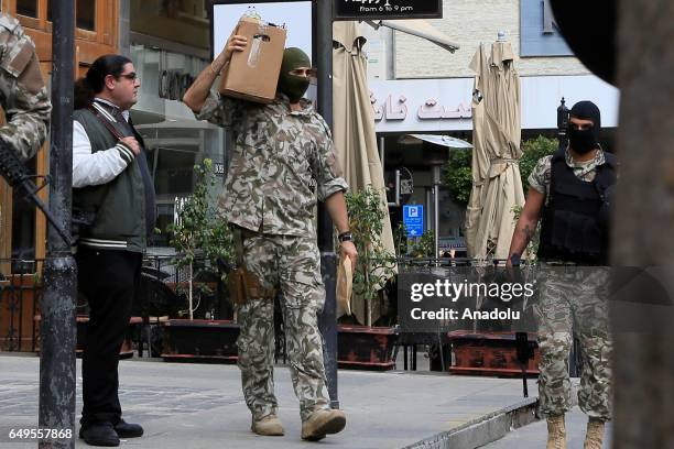 Lebanese security forces are seen during an anti-terror operation against certain exchange offices and money transfer companies, which were allegedly...