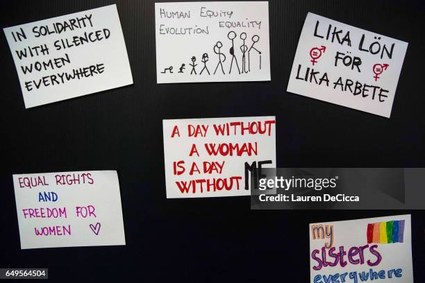 Women display their personal messages on index cards to be posted on the "I stand for" message board where women share why they strike on March 8,...