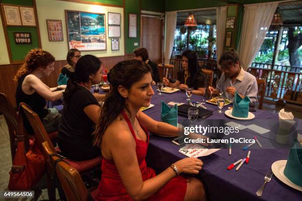 Women write their personal messages on index cards to be posted on the "I stand for" message board where women share why they strike on March 8, 2017...