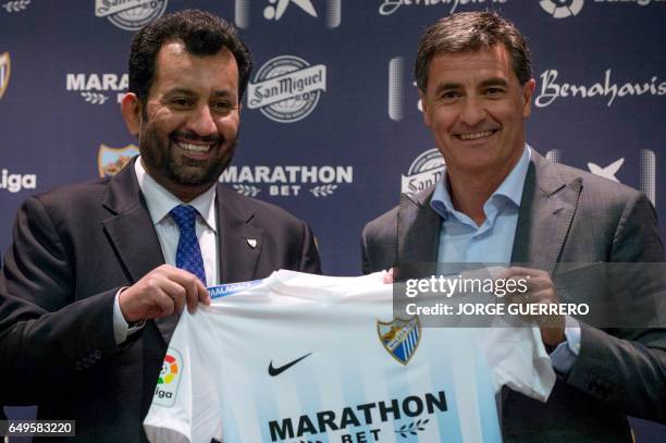 Malaga's new coach Jose Miguel Gonzalez Martin del Campo aka Michel poses with Malaga CF's chairman Sheikh Abdallah Ben Nasser Al-Thani during his...