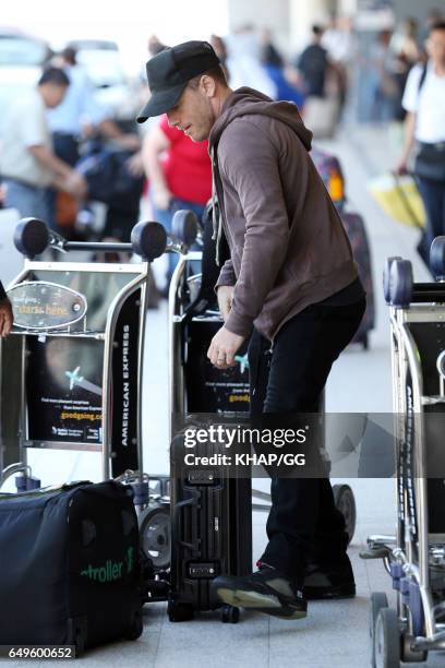 Lara Bingle, Sam Worthington and their son Rocket leave Sydney on December 1, 2015 in Sydney, Australia.