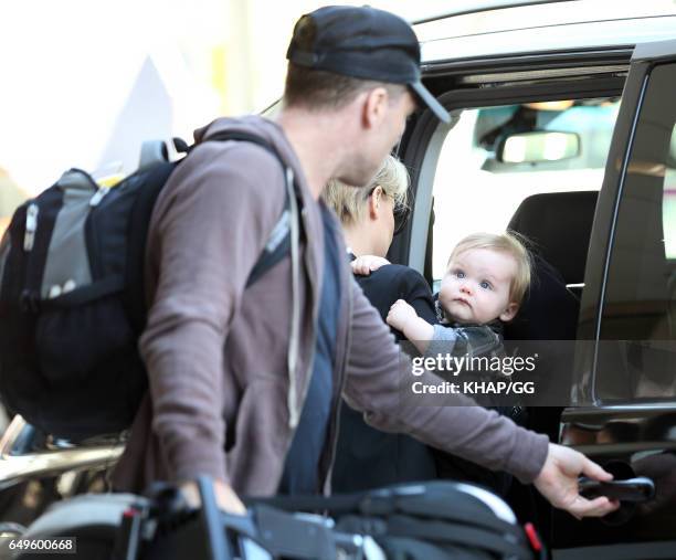 Lara Bingle, Sam Worthington and their son Rocket leave Sydney on December 1, 2015 in Sydney, Australia.