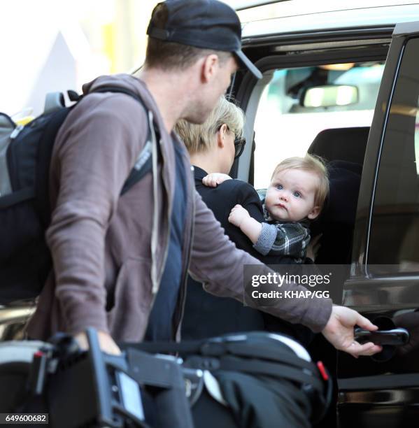 Lara Bingle, Sam Worthington and their son Rocket leave Sydney on December 1, 2015 in Sydney, Australia.