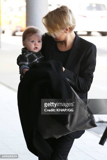 Lara Bingle, Sam Worthington and their son Rocket leave Sydney on December 1, 2015 in Sydney, Australia.