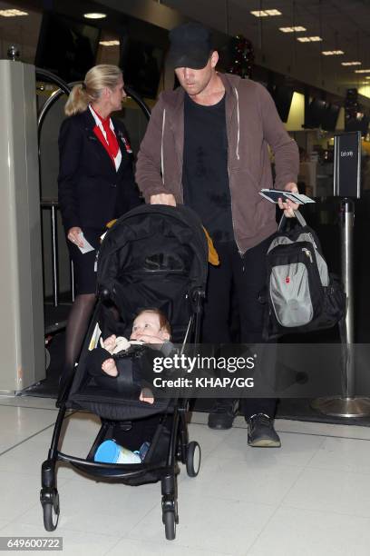 Lara Bingle, Sam Worthington and their son Rocket leave Sydney on December 1, 2015 in Sydney, Australia.