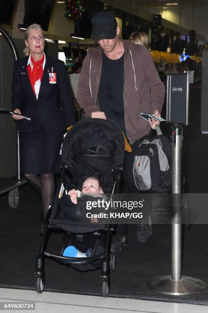 Lara Bingle, Sam Worthington and their son Rocket leave Sydney on December 1, 2015 in Sydney, Australia.