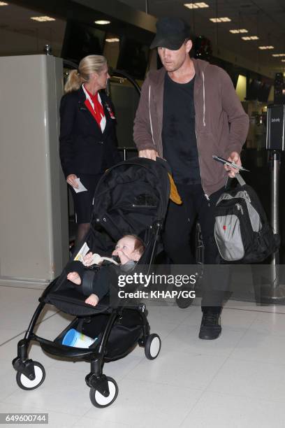 Lara Bingle, Sam Worthington and their son Rocket leave Sydney on December 1, 2015 in Sydney, Australia.