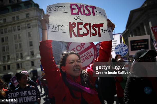 Protester holds a sign during a march and rally to support women's health programs and protest the White House global gag rule on March 8, 2017 in...