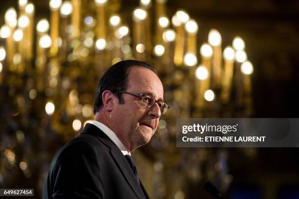 French President Francois Hollande delivers a speech during a meeting as part of the 40th International Women's Day on March 8 at the French Foreign...