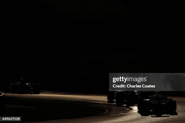 Romain Grosjean of France driving the Haas F1 Team Haas-Ferrari VF-17 Ferrari follows Marcus Ericsson of Sweden driving the Sauber F1 Team Sauber C36...