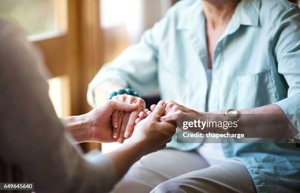 reaching out in comfort and support - caregiver and senior stock pictures, royalty-free photos & images
