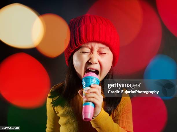 cute girl singing like a rockstar - vip nightclub stock pictures, royalty-free photos & images